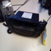 A radio sitting on top of a table next to a phone.