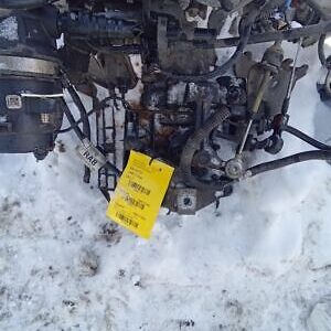 A yellow tag is attached to the engine of an atv.