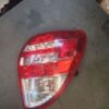 A car 's tail light is shown on the ground.