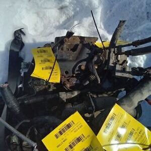 A pile of old parts with yellow tags on them.