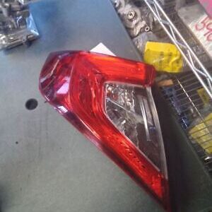 A red and white car tail light on the road