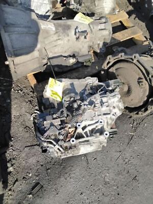 A car engine and other parts on the ground.