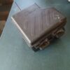 A metal box sitting on top of a table.