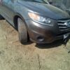 A car parked in the dirt with its tire on it.