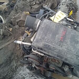 A car engine sitting on top of rubble.