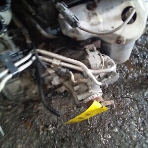 A broken motor bike engine with the yellow tag indicating it was not working.