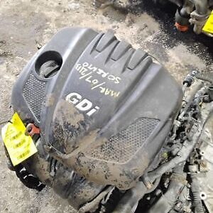 A black engine cover sitting on top of the ground.