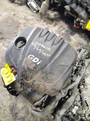 A black engine cover sitting on top of the ground.