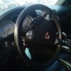 A car steering wheel with some buttons on it