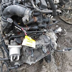 A bunch of old engines and parts that are in the dirt.