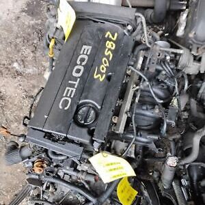 A black engine sitting on top of a pile of debris.