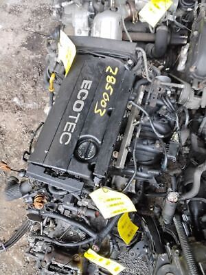 A black engine sitting on top of a pile of debris.