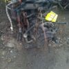 A pile of old pipes sitting on top of the ground.