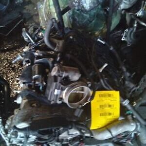 A pile of broken parts with a yellow tag on top.