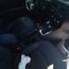 A car with the seat removed and the steering wheel turned down.