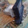 A car stereo is sitting on the floor.
