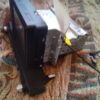 A broken tv sitting on top of the floor.