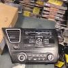 A car stereo is sitting on the floor.