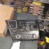 A car stereo is sitting on the floor.