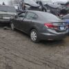 A couple of cars parked in the mud.