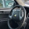 A steering wheel of a car with the dashboard and steering wheel turned down.