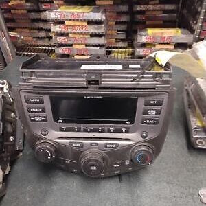 A car stereo is sitting on the floor.