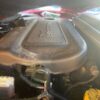 A close up of the engine cover on an older car.