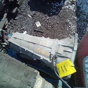 A broken down train car with debris on the ground.