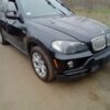 A black bmw parked on the side of a road.