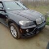 A black bmw parked on the side of a road.