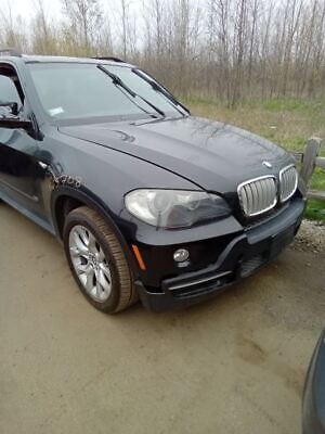 A black bmw parked on the side of a road.