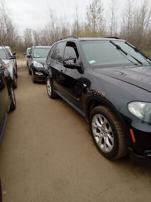 A line of cars parked on the side of a road.