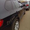 A black bmw parked on the side of a road.
