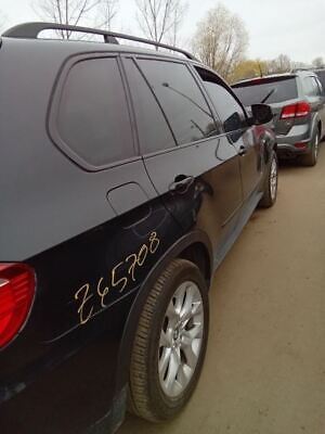 A black bmw parked on the side of a road.