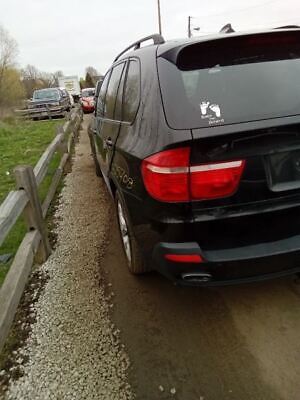 A black car is parked on the side of a road.