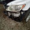 A white car that has been smashed in the front.