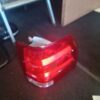 A red tail light sitting on top of the floor.