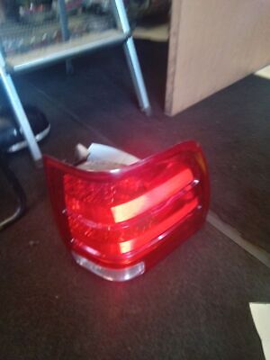 A red tail light sitting on top of the floor.