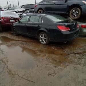 A group of cars parked in the mud.