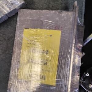 A package of yellow paper wrapped in plastic.