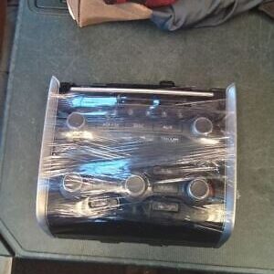 A box of wrenches wrapped in plastic on top of a table.