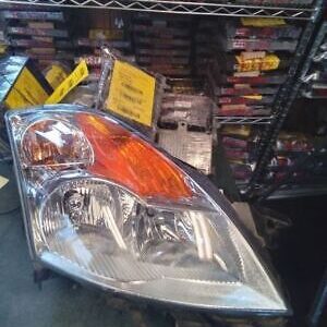 A car headlight sitting on top of a shelf.