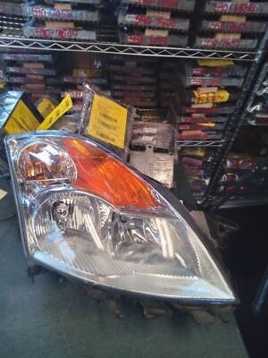 A car headlight sitting on top of a shelf.