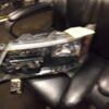 A black leather chair with a car headlight on it