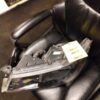 A black leather chair with a broken arm rest.