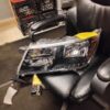 A black leather chair with a broken headlight.