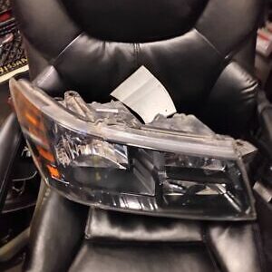 A black leather chair with a car headlight on it