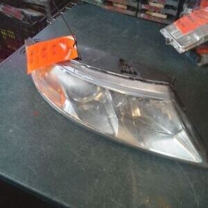 A car headlight with an orange tag on it.