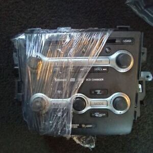 A car stereo with some wrenches wrapped in plastic.