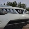 A close up of the front bumper on a white car.